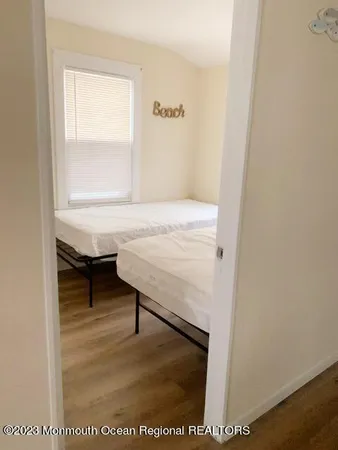 a view of room with window and wooden floor