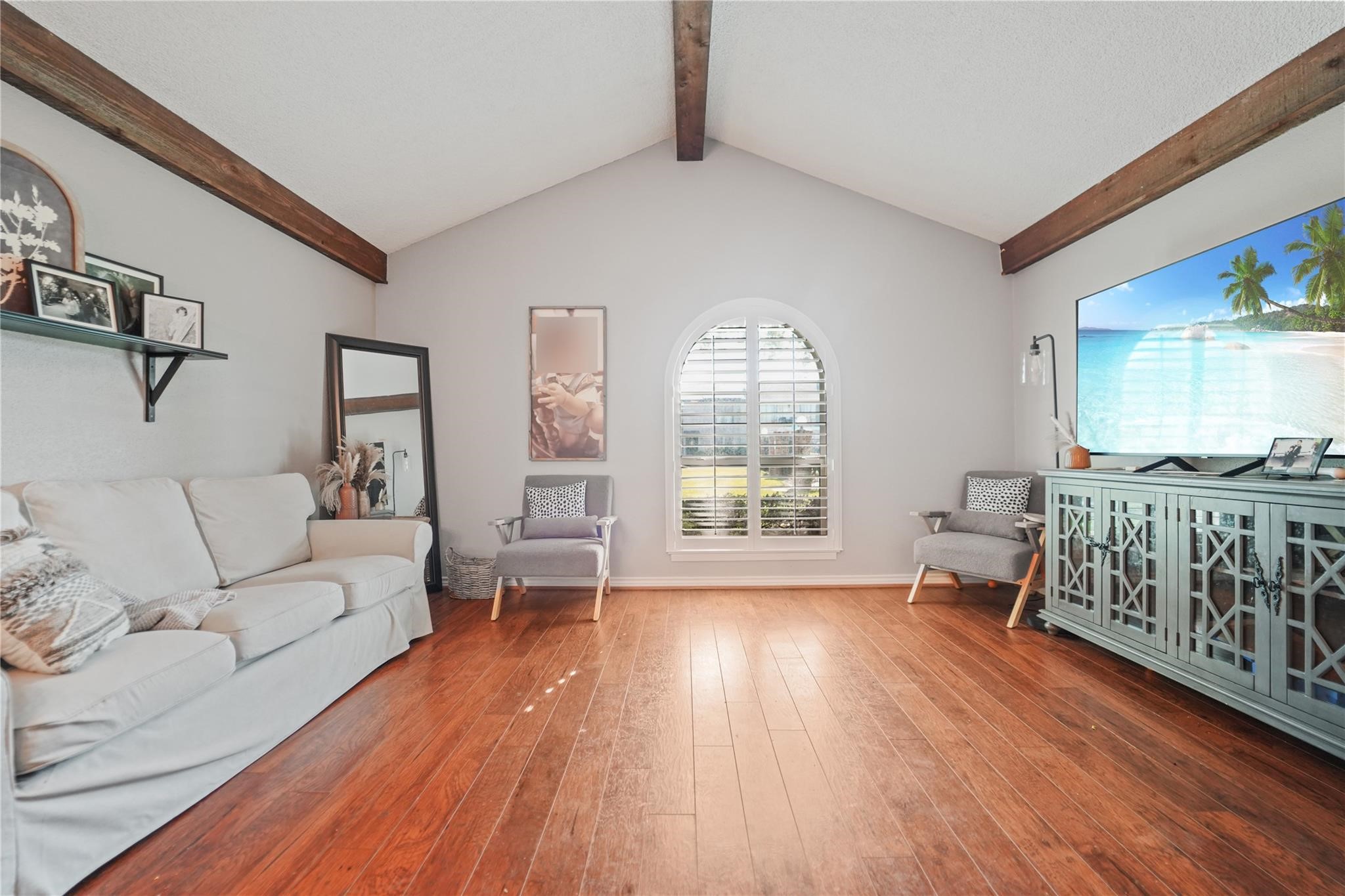 a living room with furniture and a wooden floor