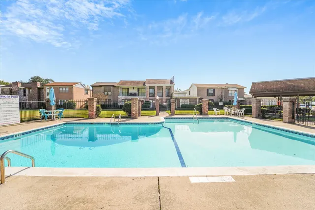 a view of a swimming pool with lawn chairs