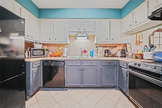 a kitchen with cabinets and appliances