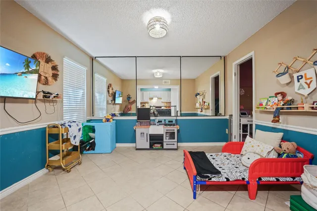 a bedroom with furniture and a large window