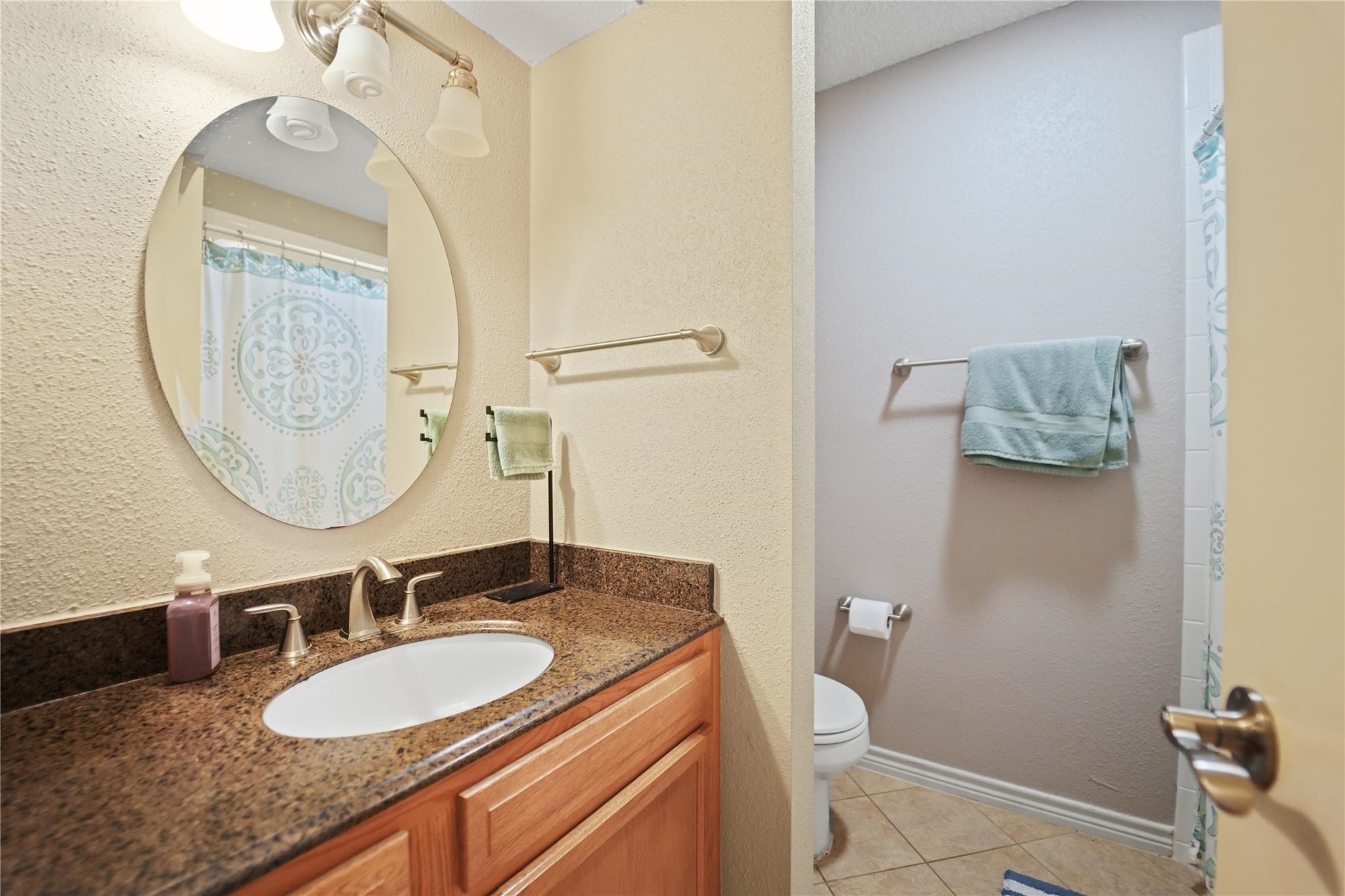 1314 Town Circle, Unit 1 Baytown, TX 77520 - Photo 10 of 17 a bathroom with a granite countertop double vanity sink and a mirror