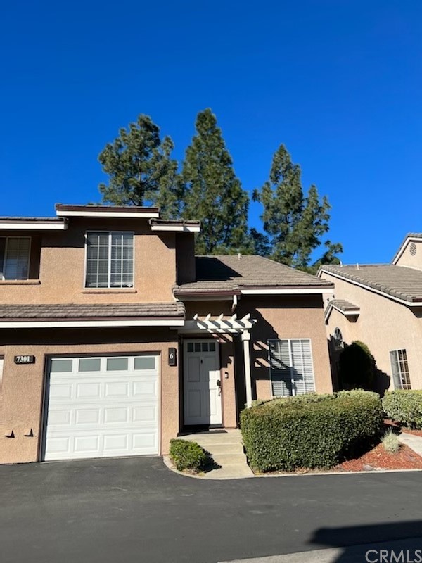 7301 Belpine Place, Unit 6 Rancho Cucamonga, CA 91730 - Photo 1 of 1 a front view of a house with a yard