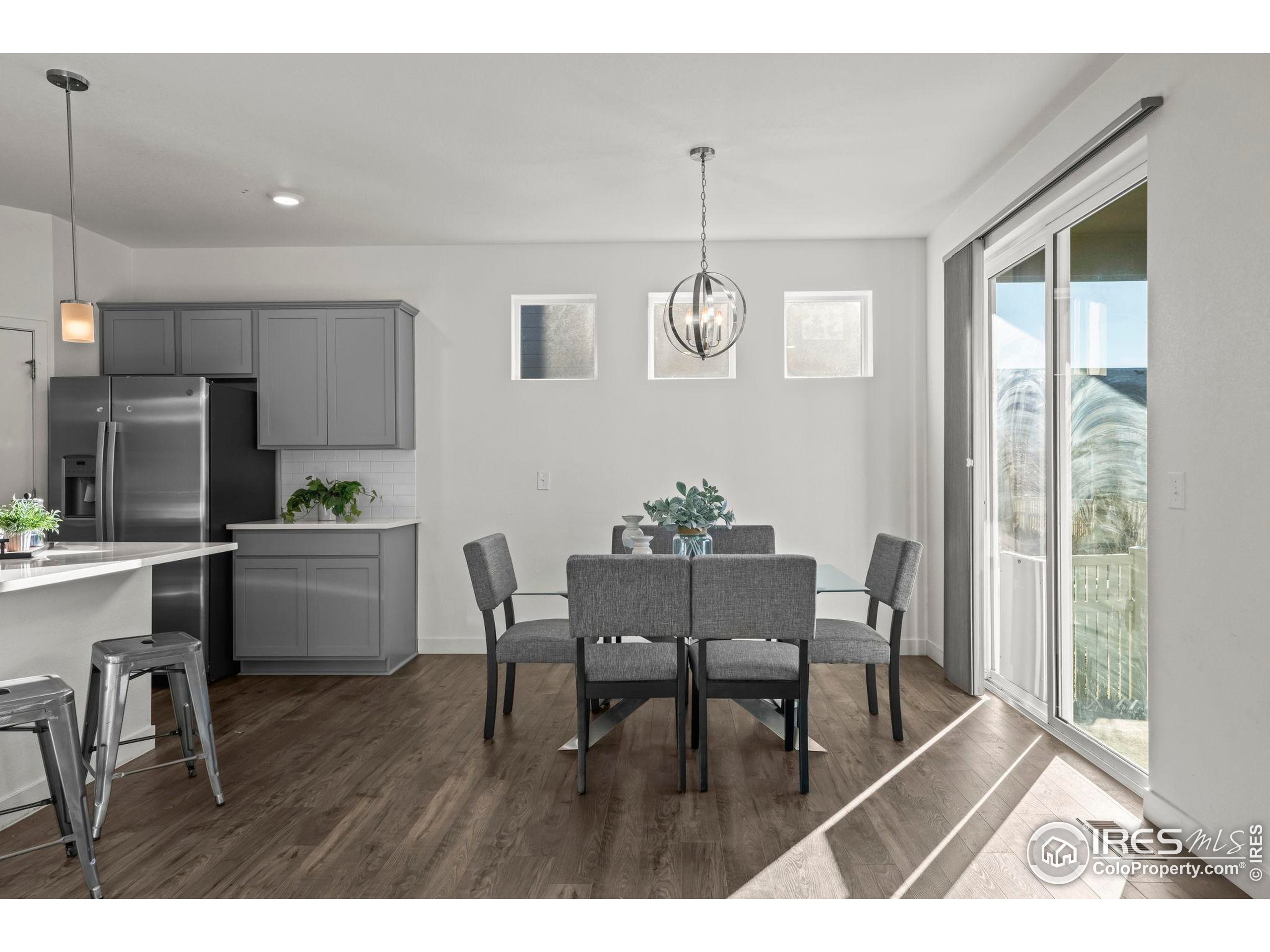 8957 Ferncrest Street Firestone, CO 80504 - Photo 20 of 50 a view of a dining room with furniture and wooden floor