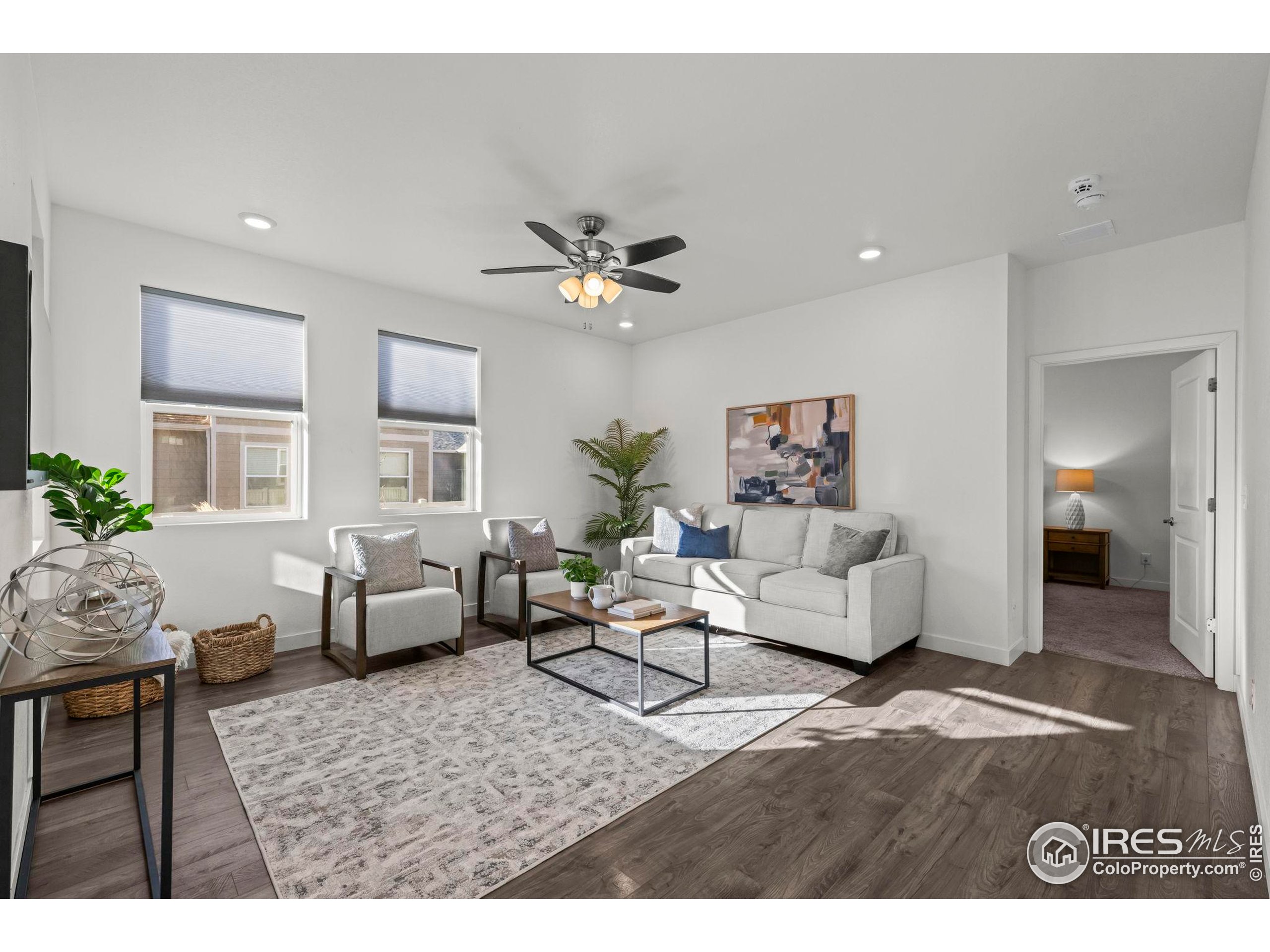 8957 Ferncrest Street Firestone, CO 80504 - Photo 24 of 50 a living room with furniture and a ceiling fan