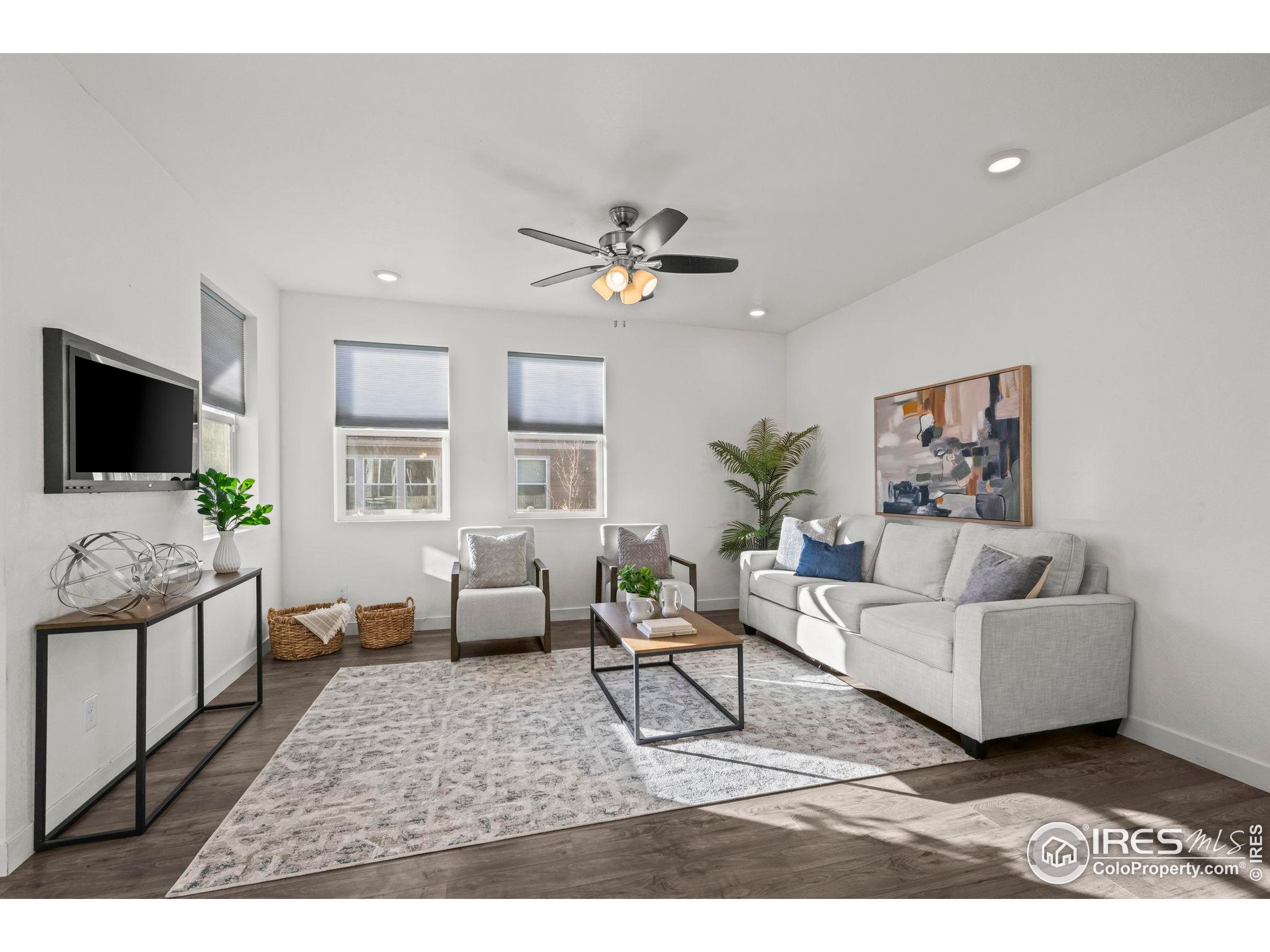 8957 Ferncrest Street Firestone, CO 80504 - Photo 26 of 50 a living room with furniture and a flat screen tv