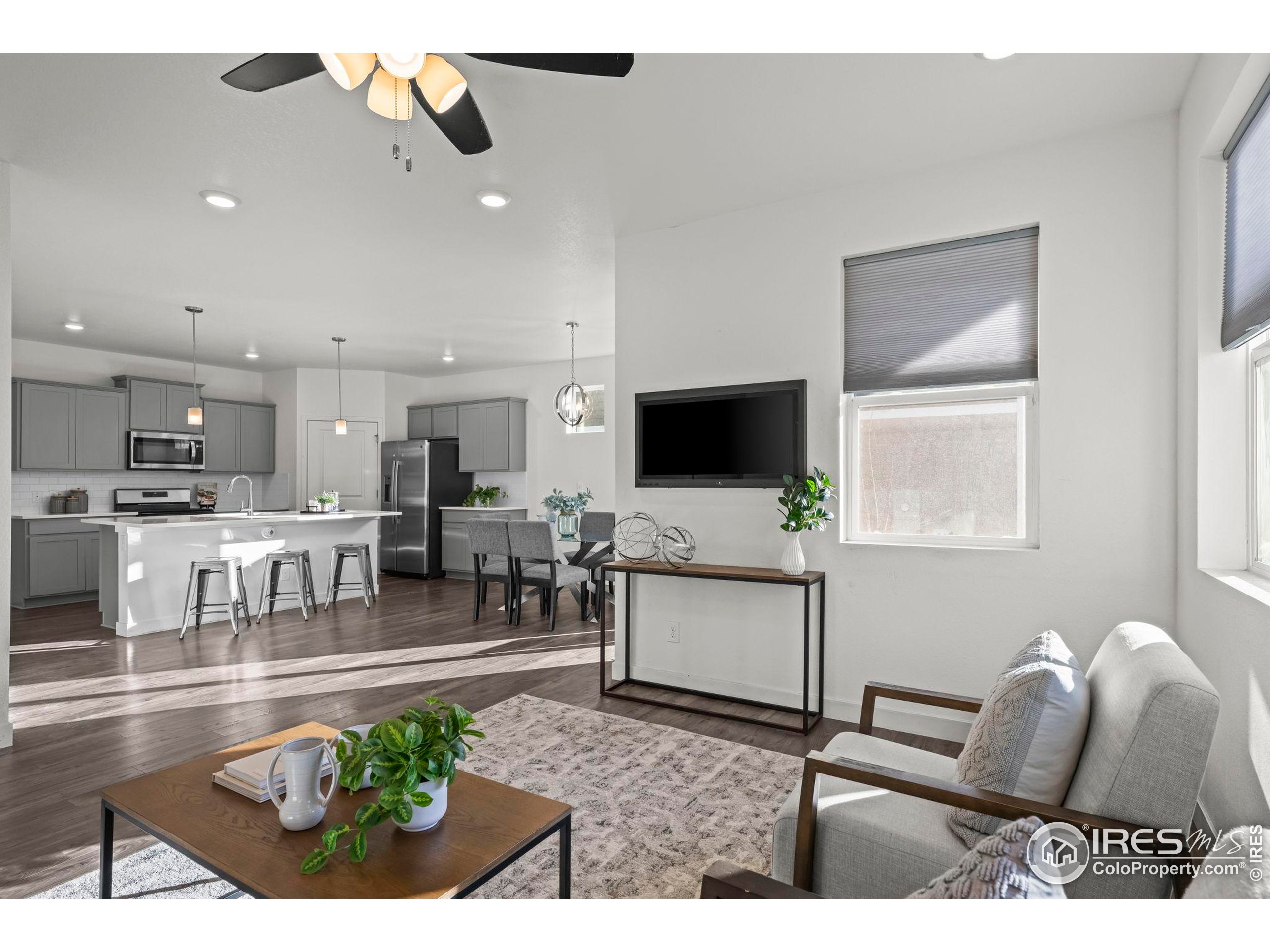 8957 Ferncrest Street Firestone, CO 80504 - Photo 29 of 50 a living room with furniture and a flat screen tv