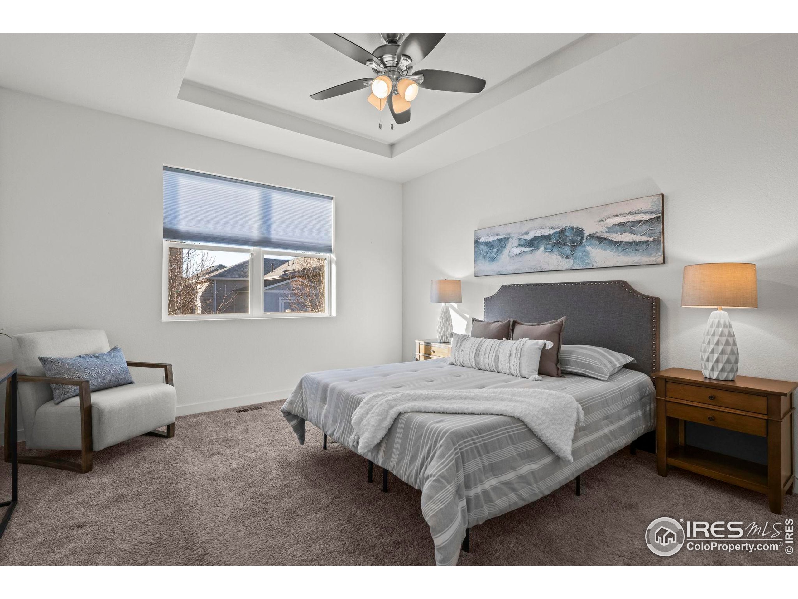 8957 Ferncrest Street Firestone, CO 80504 - Photo 30 of 50 a bedroom with a bed and a chandelier