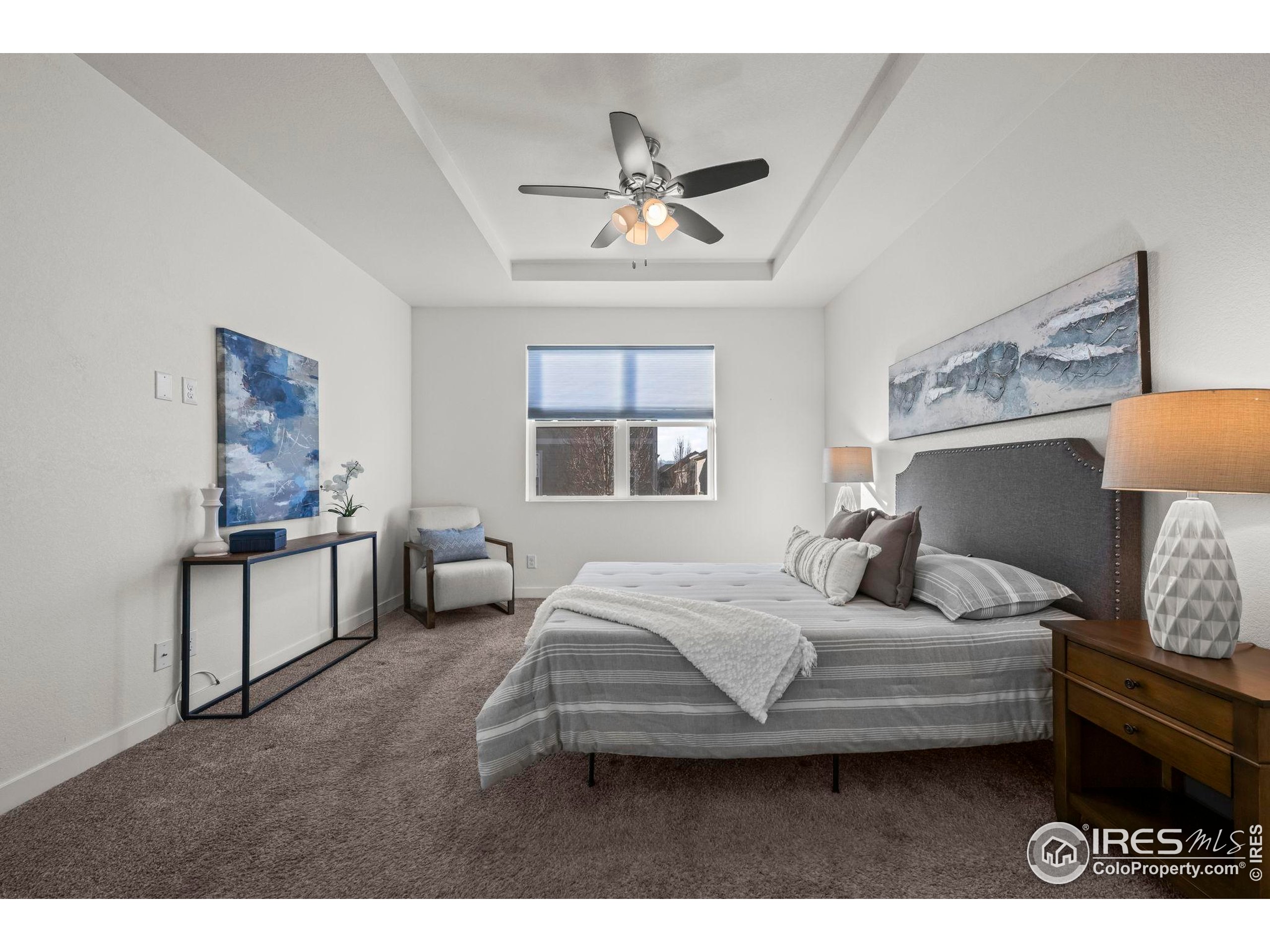 8957 Ferncrest Street Firestone, CO 80504 - Photo 31 of 50 a bedroom with a bed and a chandelier