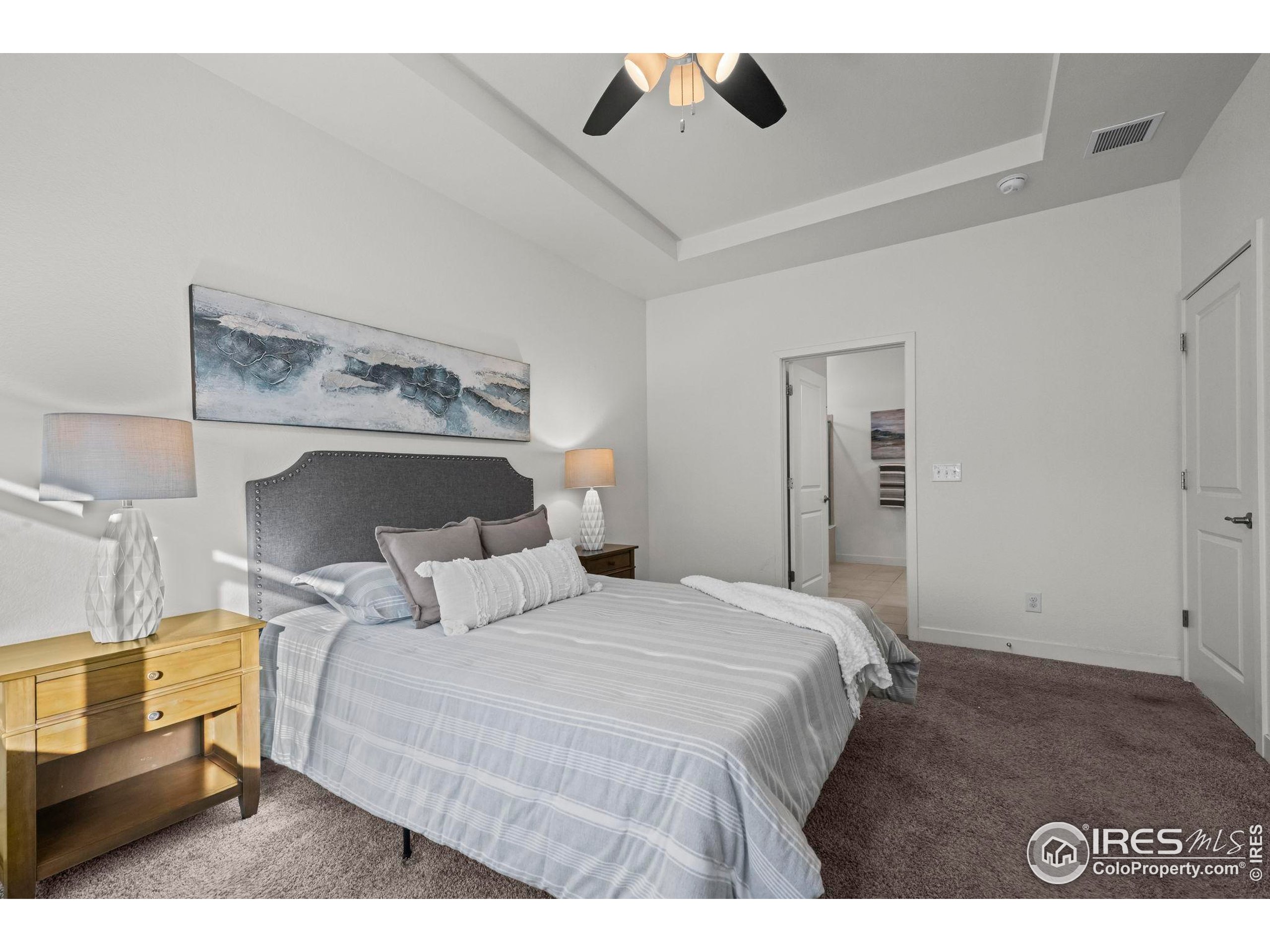 8957 Ferncrest Street Firestone, CO 80504 - Photo 32 of 50 a bedroom with a bed and wooden floor