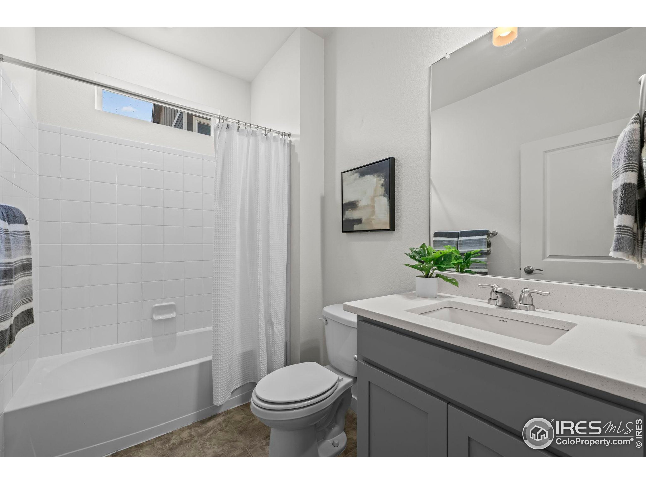 8957 Ferncrest Street Firestone, CO 80504 - Photo 9 of 50 a bathroom with a sink a toilet and shower