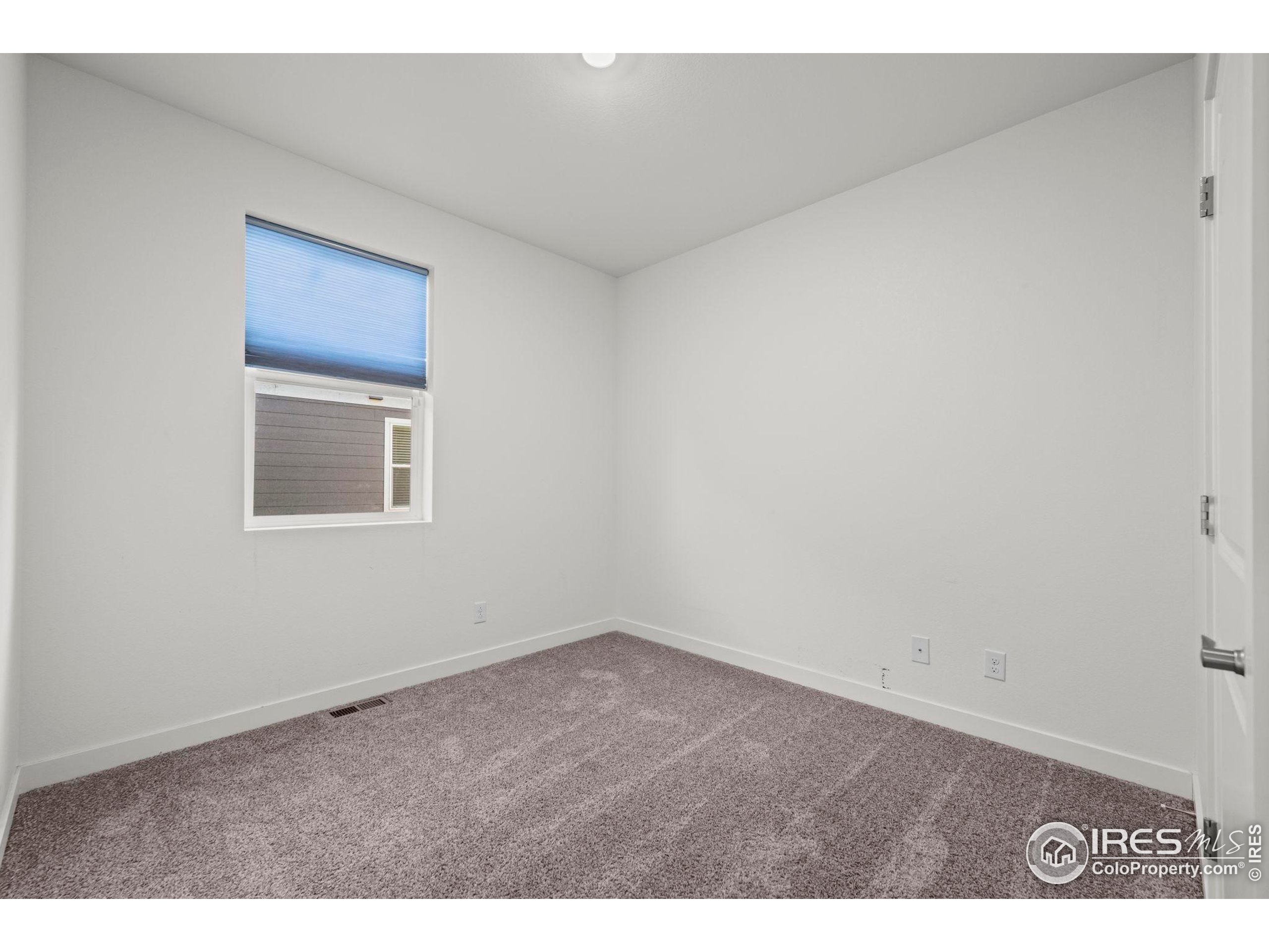 8957 Ferncrest Street Firestone, CO 80504 - Photo 10 of 50 a view of an empty room with a window