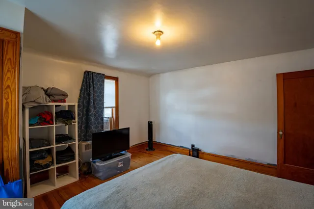 a bedroom with a bed and a chair