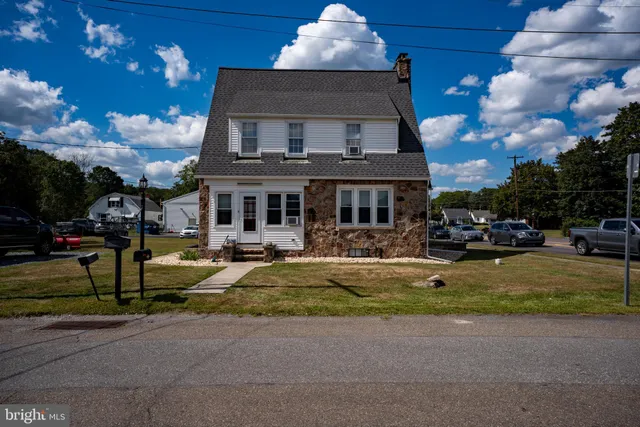 a front view of a house with swimming pool having outdoor seating