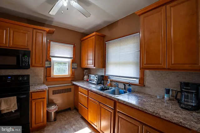 a kitchen with a sink stove and cabinets