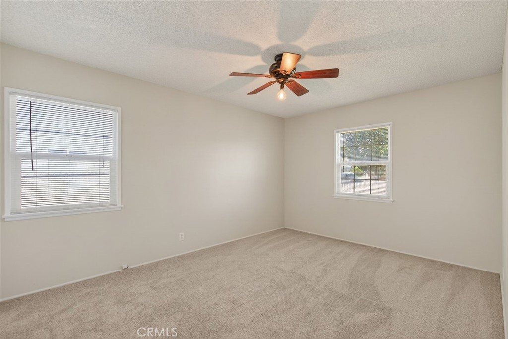 6845 Barcelona Way Riverside, CA 92504 - Photo 13 of 17 Bedroom number 2, with ceiling fan, and brand new carpet and brand new paint