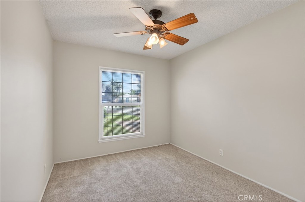 6845 Barcelona Way Riverside, CA 92504 - Photo 14 of 17 Bedroom number 3, with ceiling fan, and brand new carpet and brand new paint.