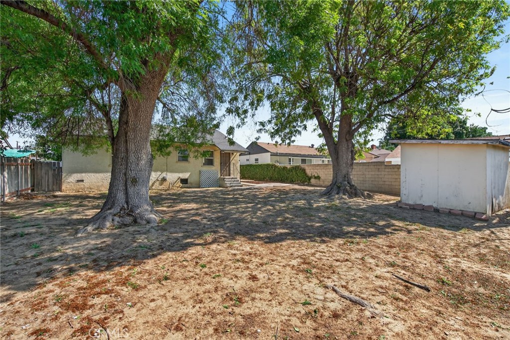 6845 Barcelona Way Riverside, CA 92504 - Photo 15 of 17 Spacious backyard with mature shade trees and shed, with enough space to add a pool, and even an ADU.