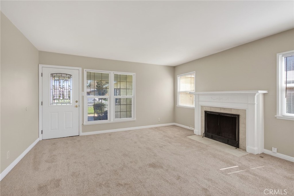 6845 Barcelona Way Riverside, CA 92504 - Photo 4 of 17 Living room with wood-burning and gas fireplace, brand new carpet, and brand new paint!