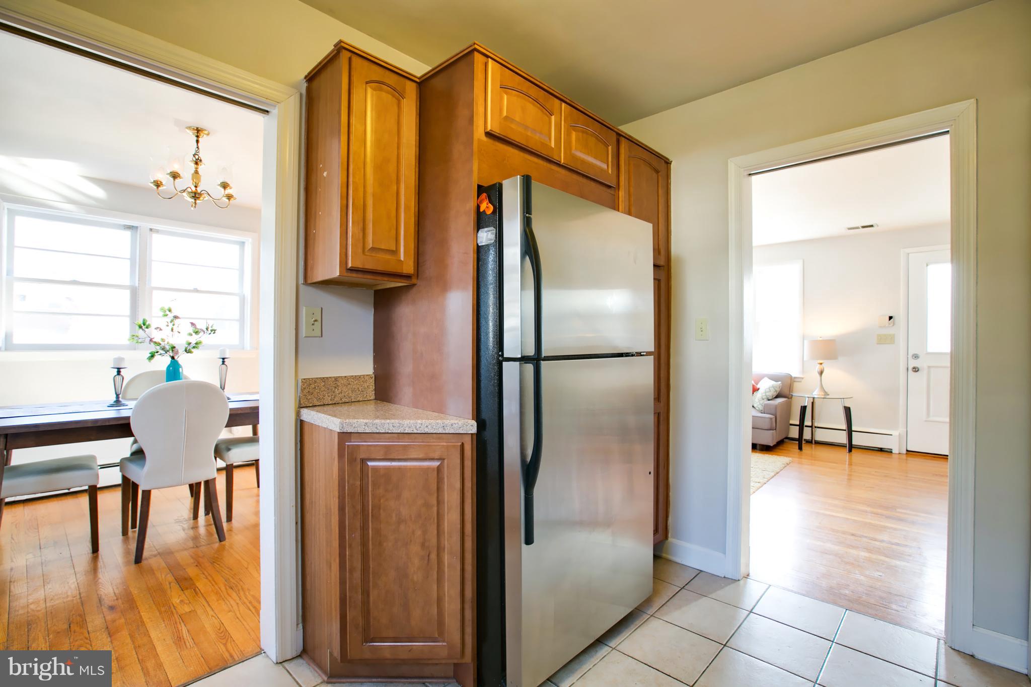 324 Aigburth Road Towson, MD 21286 - Photo 11 of 29 a kitchen with stainless steel appliances granite countertop a refrigerator and a view of living room