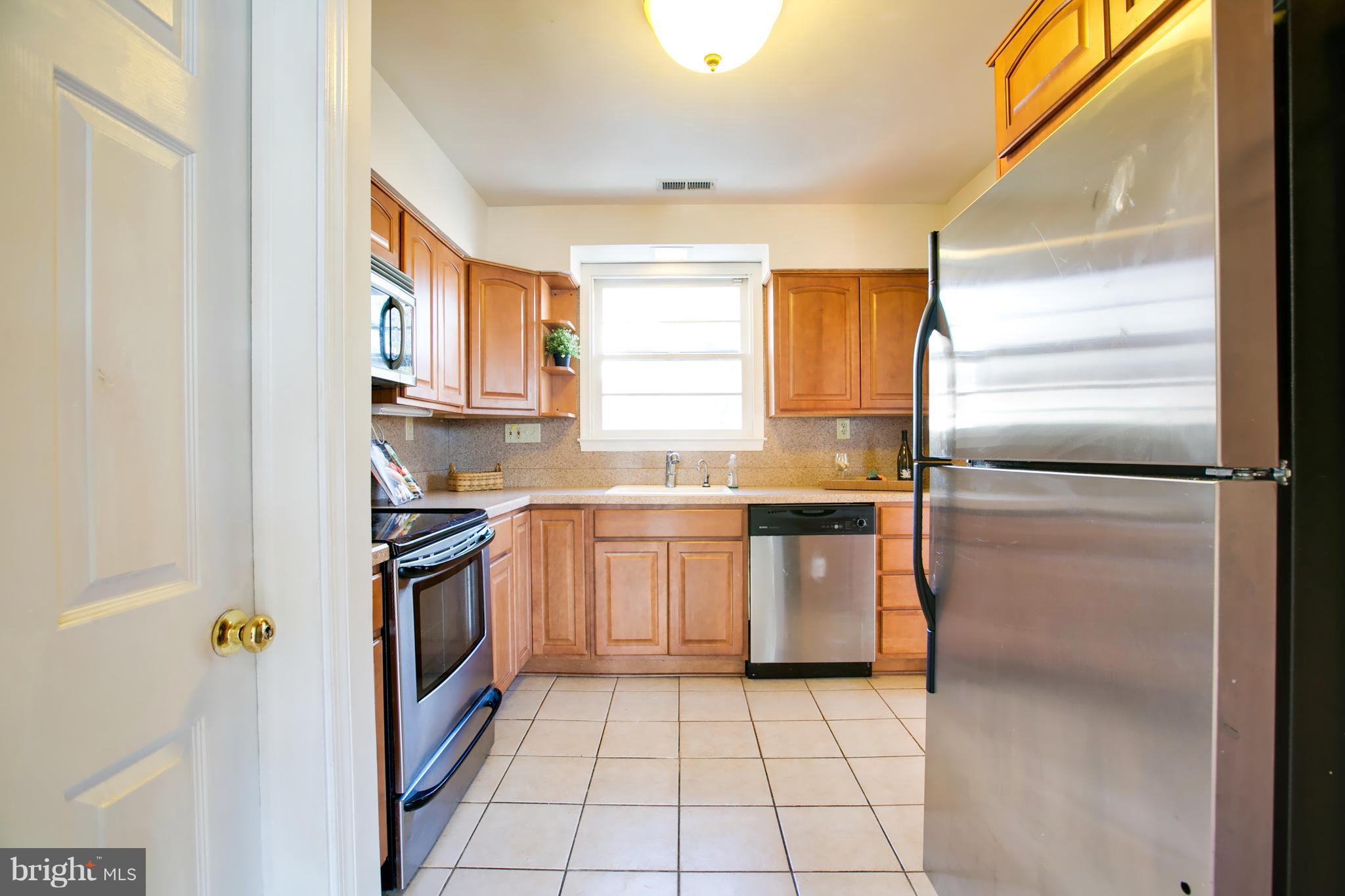 324 Aigburth Road Towson, MD 21286 - Photo 12 of 29 a kitchen with granite countertop a refrigerator a sink and dishwasher