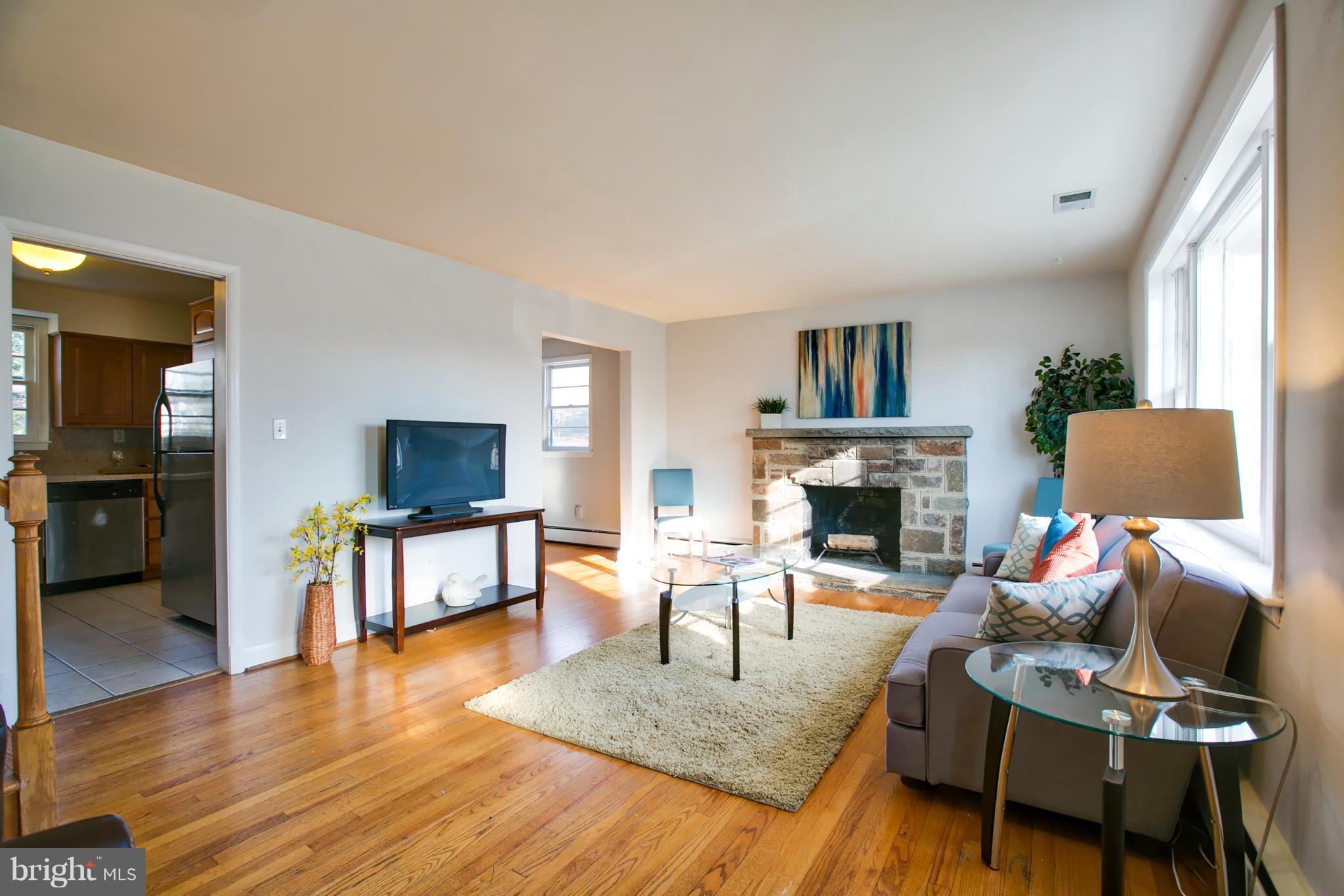 324 Aigburth Road Towson, MD 21286 - Photo 4 of 29 a living room with furniture a fireplace and a flat screen tv
