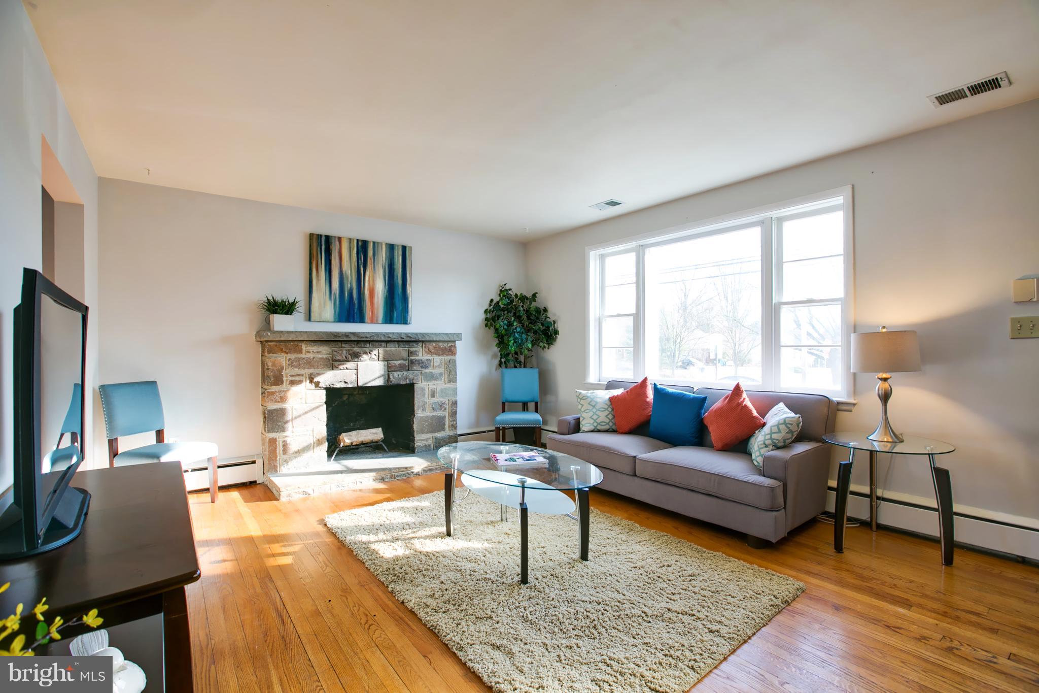 324 Aigburth Road Towson, MD 21286 - Photo 5 of 29 a living room with furniture and a fireplace