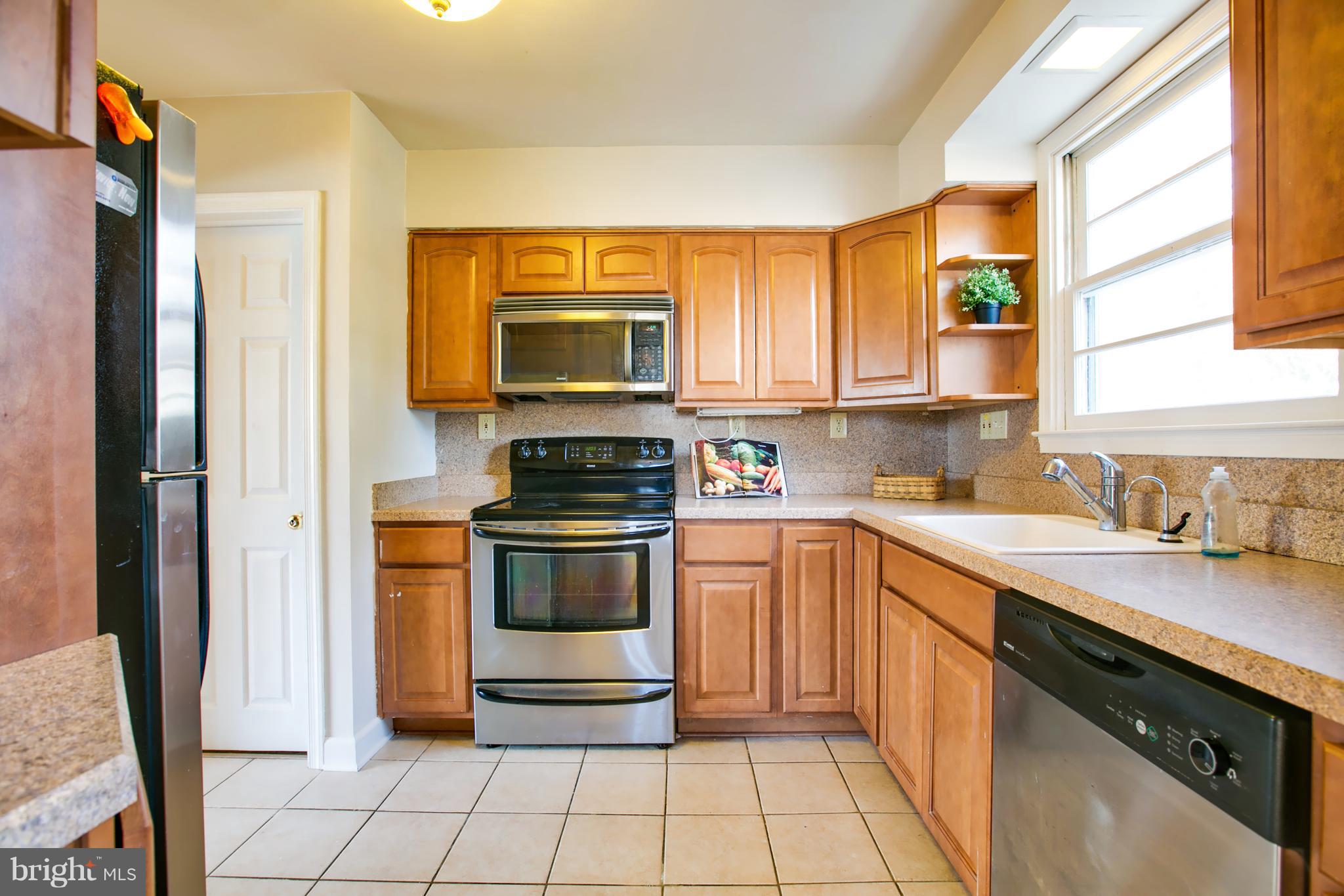 324 Aigburth Road Towson, MD 21286 - Photo 10 of 29 a kitchen with stainless steel appliances a stove a sink and a microwave