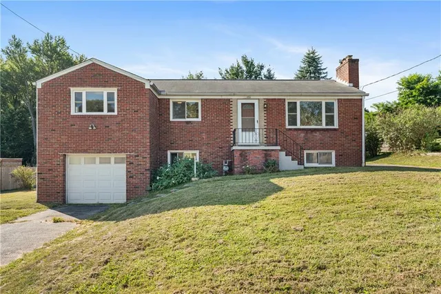 a front view of a house with a garden