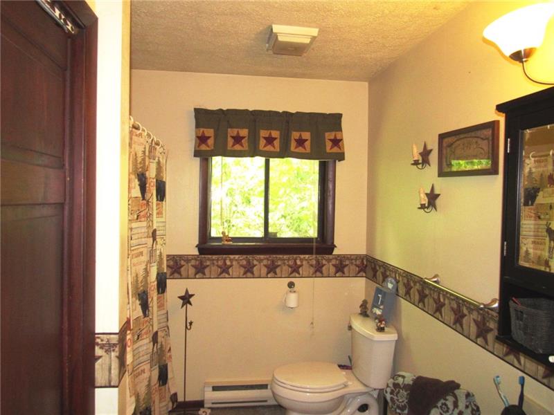 207 Clinton Road Normalville, PA 15469 - Photo 13 of 25 Full bath on the main living level. There's a linen closet on the left.