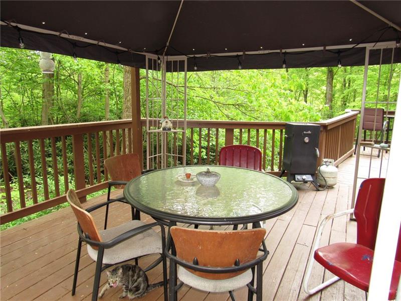 207 Clinton Road Normalville, PA 15469 - Photo 22 of 25 Off to the back right you can see the table and chairs that the sun room opens up too.
