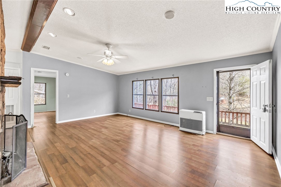 3303 Old Highway 16 Lansing, NC 28643 - Photo 12 of 30 wooden floor in an empty room with a window