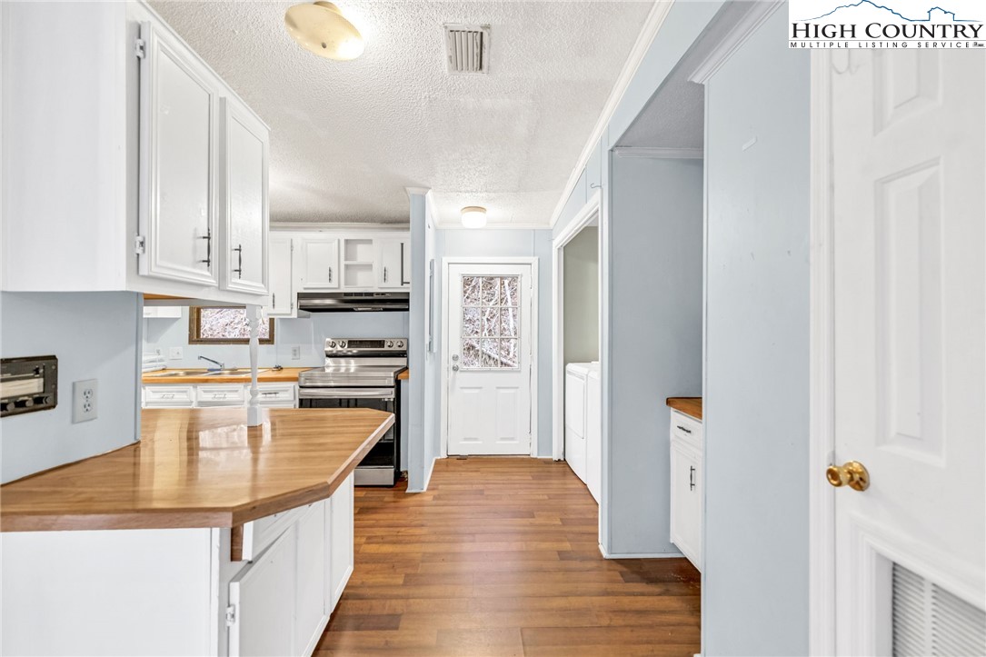 3303 Old Highway 16 Lansing, NC 28643 - Photo 16 of 30 a kitchen with stainless steel appliances granite countertop a refrigerator and a stove top oven