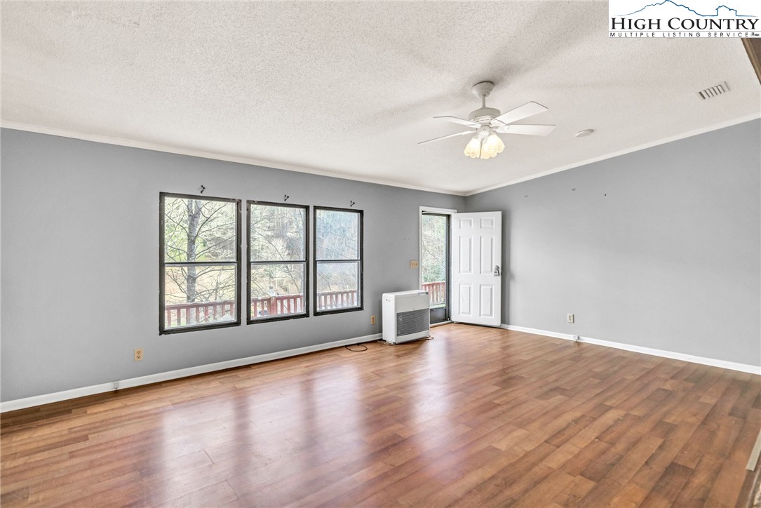 3303 Old Highway 16 Lansing, NC 28643 - Photo 23 of 30 wooden floor in an empty room with a window