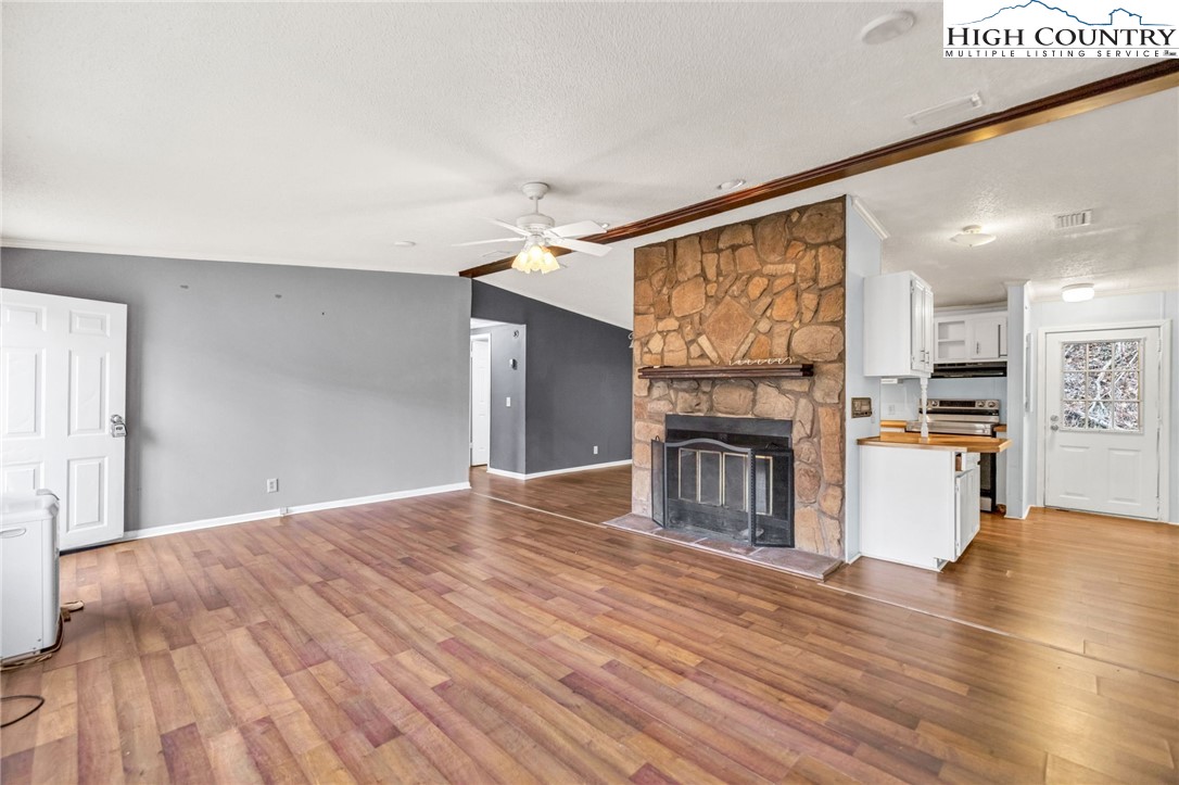 3303 Old Highway 16 Lansing, NC 28643 - Photo 24 of 30 a view of empty room with kitchen and fireplace