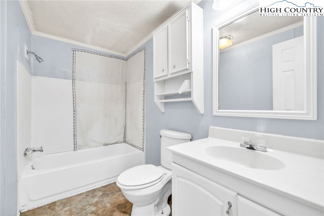 3303 Old Highway 16 Lansing, NC 28643 - Photo 26 of 30 a bathroom with a sink toilet and shower