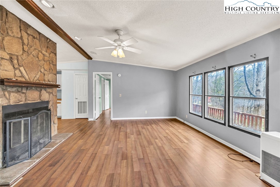 3303 Old Highway 16 Lansing, NC 28643 - Photo 10 of 30 a view of an empty room with wooden floor and a window