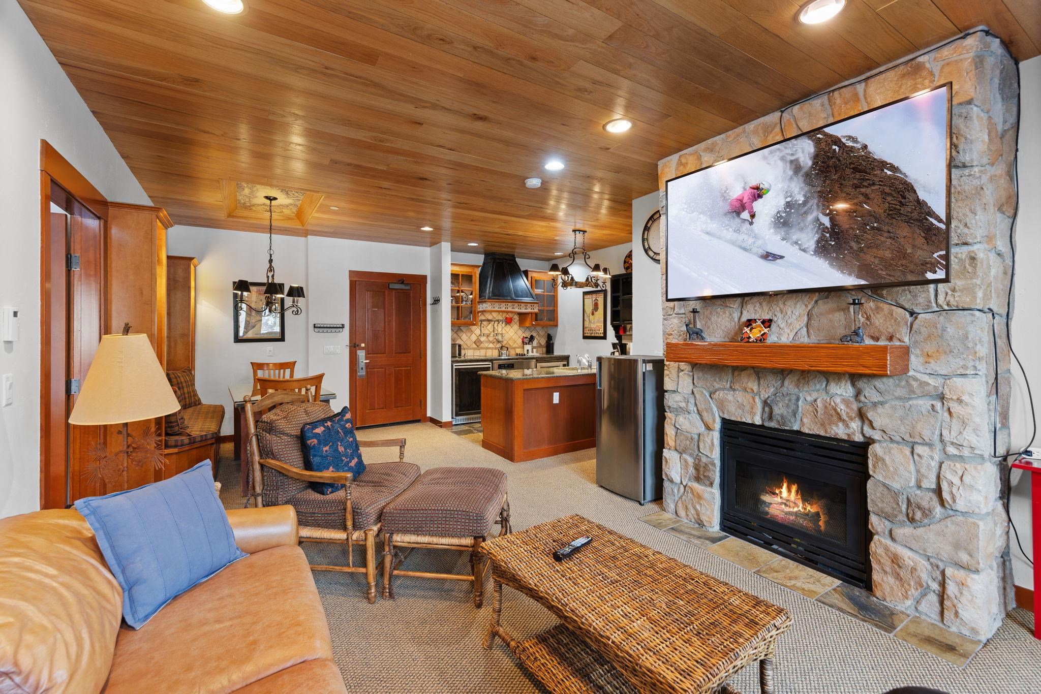 1985 Olympic Vly Road, Unit 216 (2216) Olympic Valley, CA 96146 - Photo 12 of 25 a living room with furniture a red wall and a fireplace