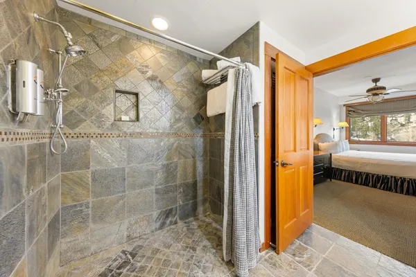 a bathroom with a shower and a sink