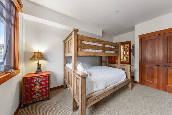 a bedroom with a bed and a window