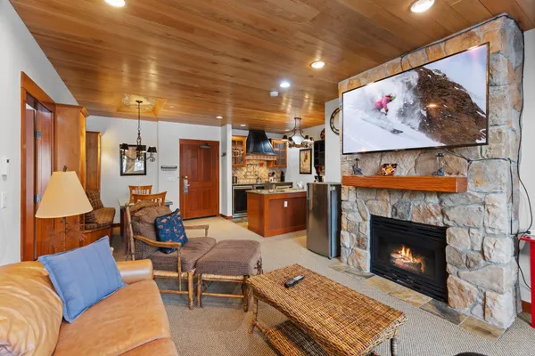 a living room with furniture a red wall and a fireplace
