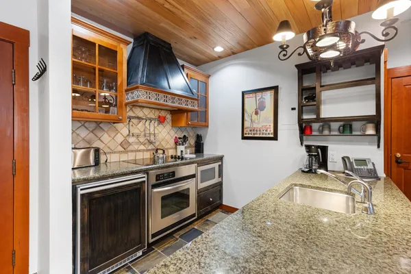 a kitchen with stainless steel appliances granite countertop a stove and cabinets