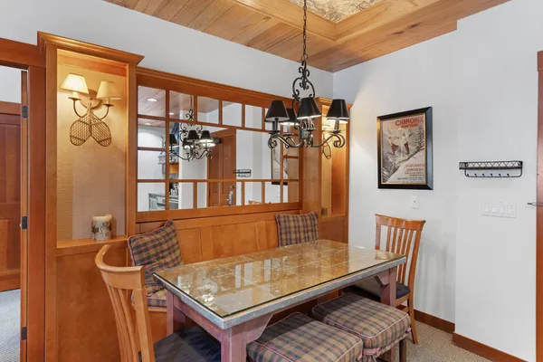 a living room with furniture a chandelier and a window
