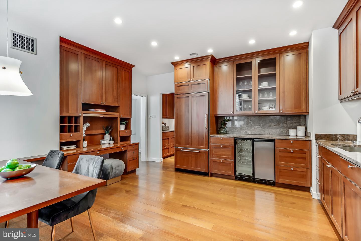 1820 Rittenhouse Square, Unit 1601 Philadelphia, PA 19103 - Photo 23 of 53 a open kitchen with stainless steel appliances granite countertop a refrigerator a stove top oven and a dining table with wooden floor