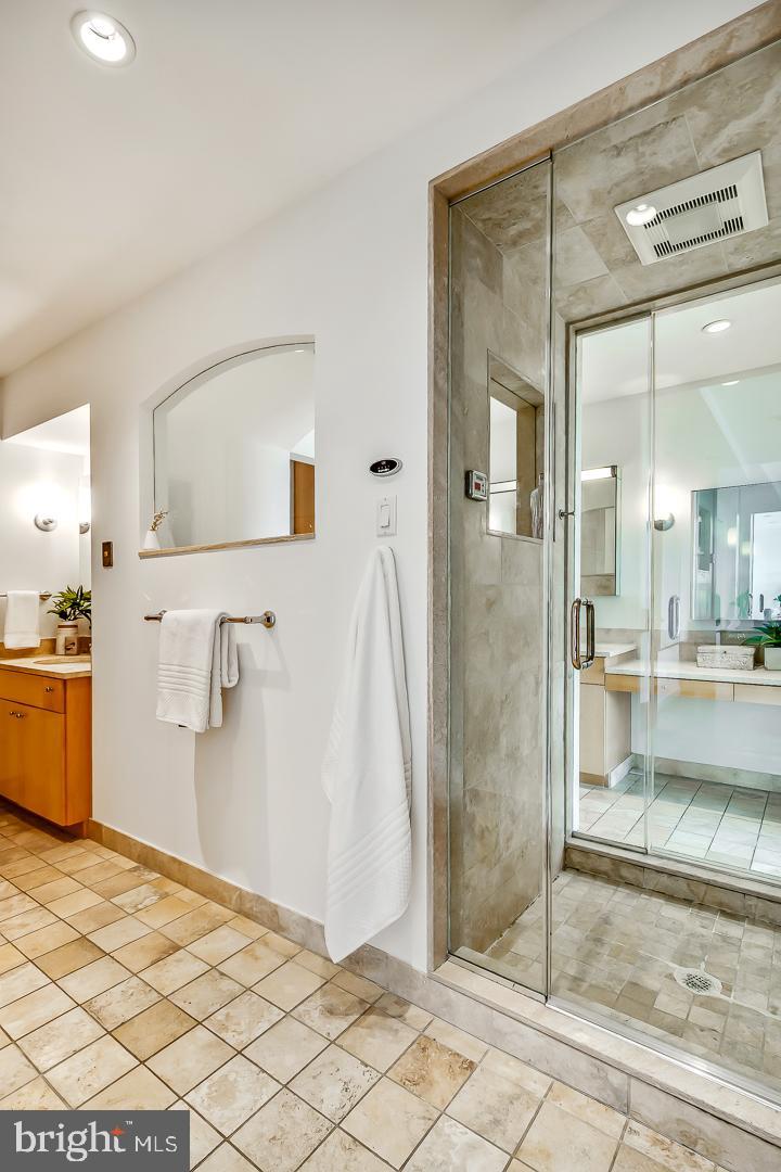 1820 Rittenhouse Square, Unit 1601 Philadelphia, PA 19103 - Photo 40 of 53 a bathroom with a tub a mirror and a shower