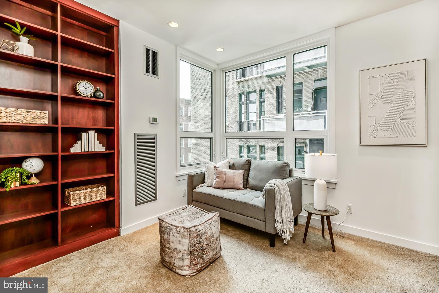 1820 Rittenhouse Square, Unit 1601 Philadelphia, PA 19103 - Photo 45 of 53 a living room with furniture and a book shelf