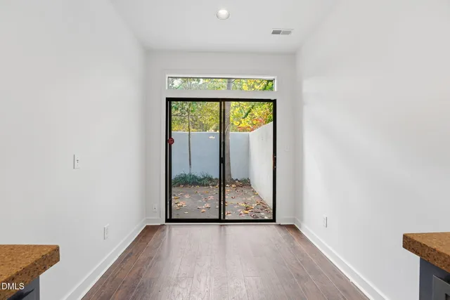 a view of an entryway with wooden floor