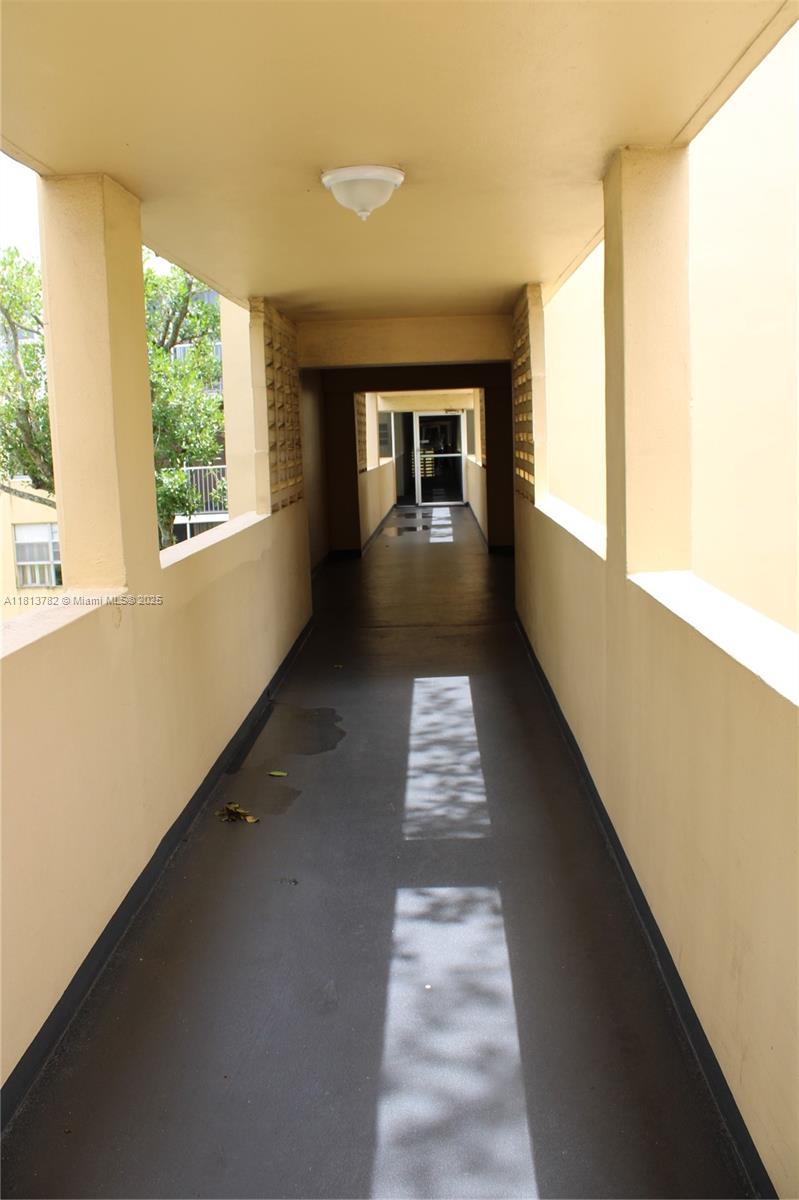 922 Northeast 199th Street, Unit 3D 304 Miami, FL 33179 - Photo 6 of 7 a view of a porch with wooden floor and windows