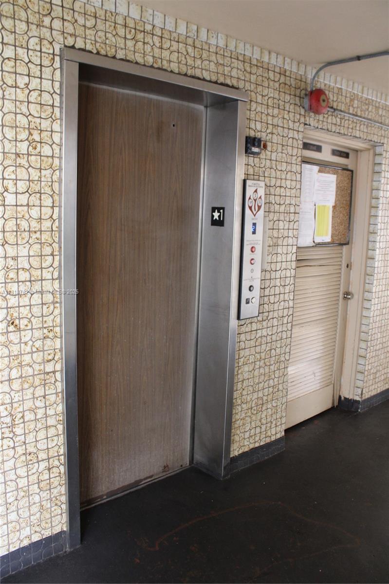 922 Northeast 199th Street, Unit 3D 304 Miami, FL 33179 - Photo 7 of 7 an empty room with wooden floor windows and closet