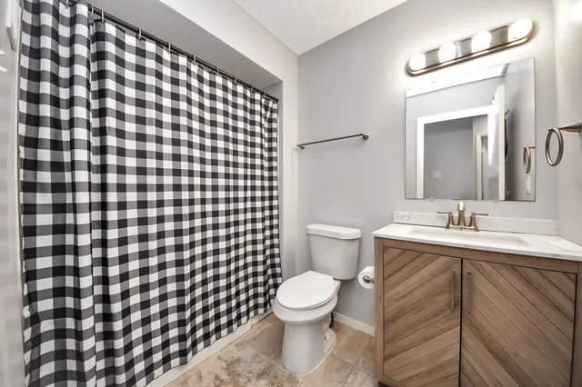 a bathroom with a sink toilet and a mirror